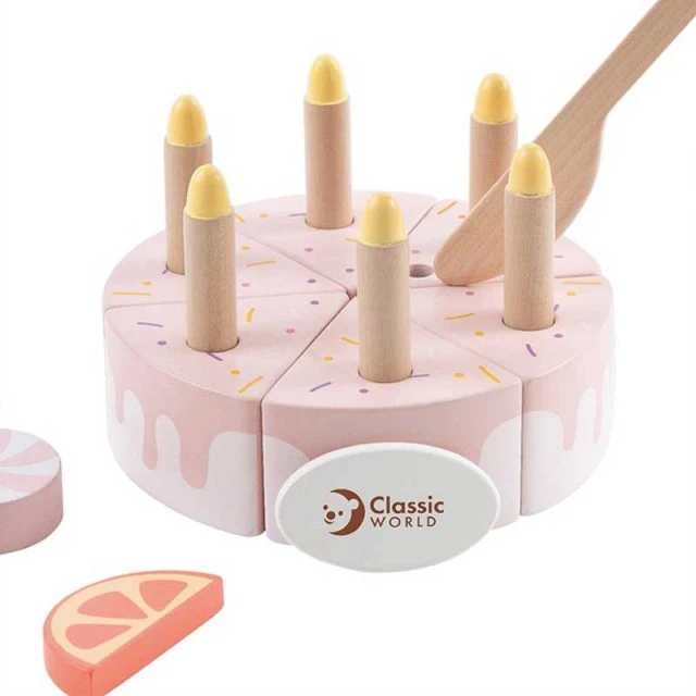 Children’s cake made of wood with pastel pink candles