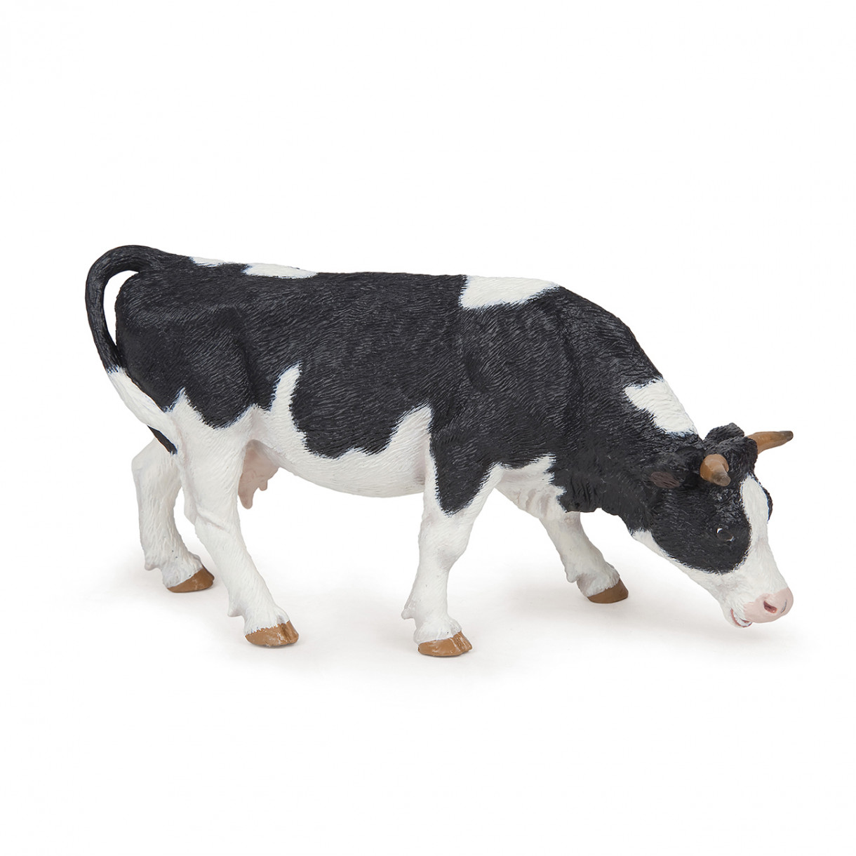 Black and white grazing cow figurine