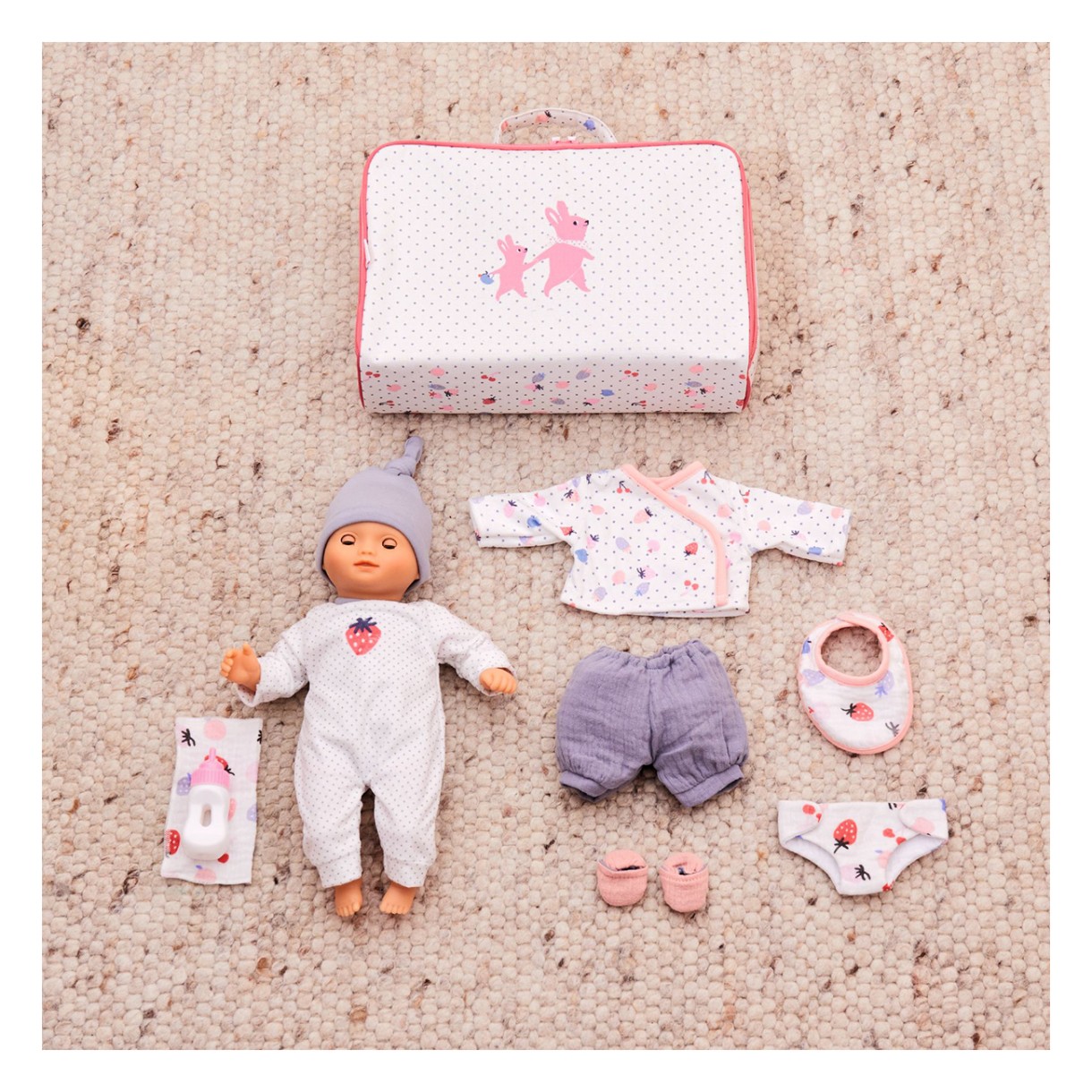 Baby doll toy in a suitcase with clothes and accessories